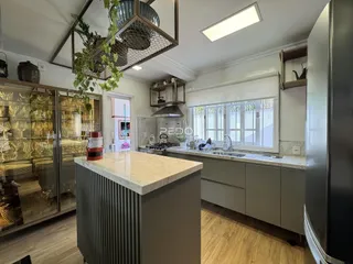 Cozinha moderna com ilha e armários em um imóvel em Lajeado, Brasil.