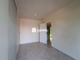 Hall de entrada com piso de cerâmica claro.