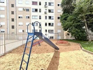Área externa com estrutura de playground em terra.
