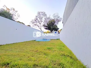 Vista externa mostrando um gramado e uma piscina no quintal.