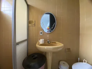 Foto de um banheiro com pia e vaso sanitário em uma residência.