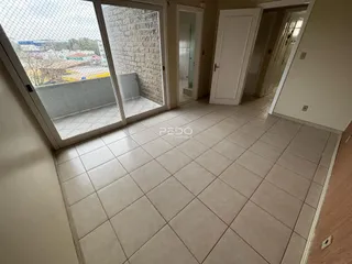 Hall de entrada com piso de cerâmica e portas de vidro.