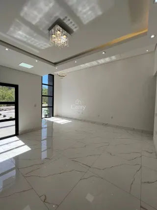 Sala de estar ampla com piso de mármore branco e iluminação clara.