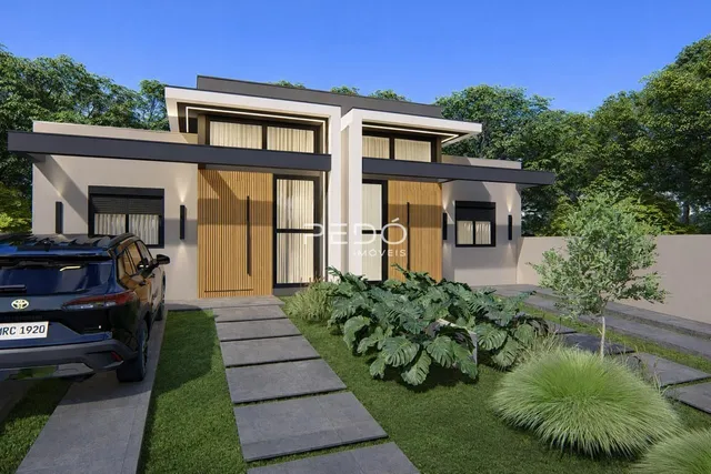 Fachada moderna de uma residência em Lajeado, Brasil, com jardim frontal e calçada.