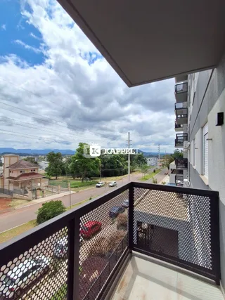 Vista da varanda de um apartamento em Lajeado, mostrando uma rua e outras construções.