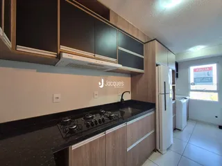 Foto de uma cozinha moderna com armários de madeira e bancadas escuras.