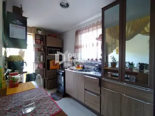Sala de estar com móveis de madeira e janelas com cortinas.