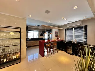 Ambiente moderno de sala de estar, jantar e cozinha em um imóvel.