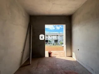 Foto de um corredor interno mostrando a abertura para o exterior da propriedade.