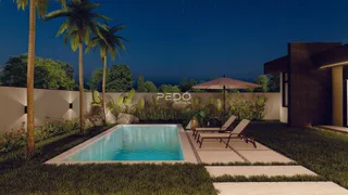 Vista noturna de uma piscina e jardim em uma propriedade.
