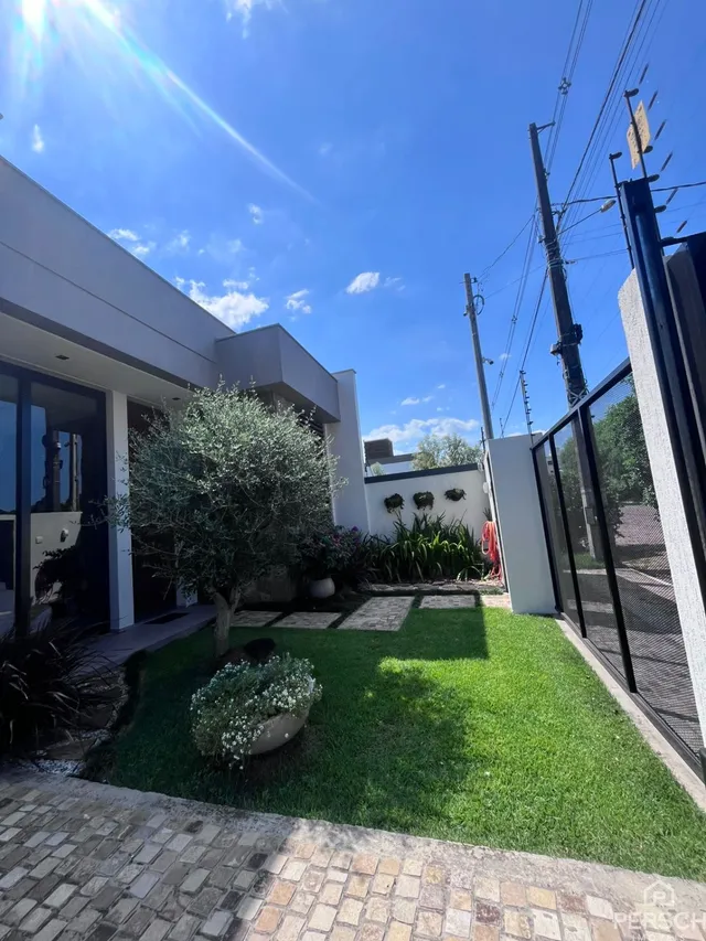 Fachada moderna de uma residência com jardim bem cuidado em Lajeado.
