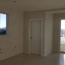 Vista interna de um corredor com paredes brancas em um imóvel.