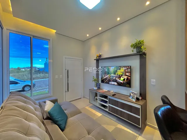 Sala de estar moderna com grande janela de vidro e decoração contemporânea.