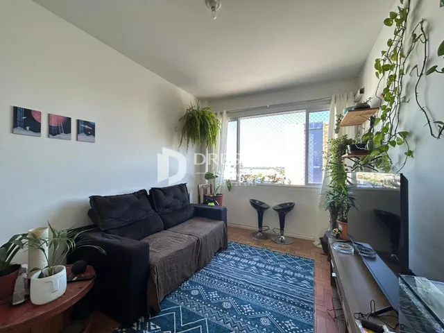 Sala de estar com sofá e vista pela janela em Lajeado.