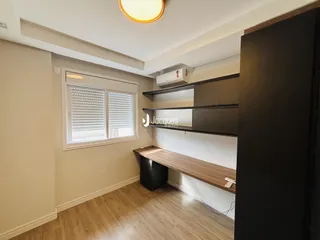 Sala de estar com piso de madeira e janela na residência.