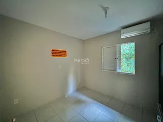 Vista interna de um corredor com piso de cerâmica e janela.