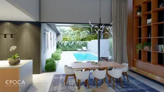Sala de estar com vista para piscina e jardim em Lajeado.
