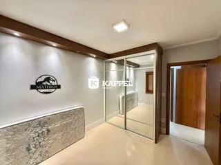 Ambiente interno com piso claro e painel decorativo na sala.