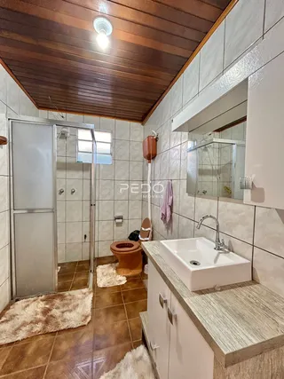 Foto de um banheiro com piso de cerâmica e box de vidro.