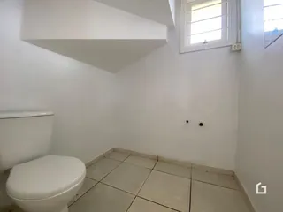 Foto de um banheiro interno com piso de cerâmica e paredes brancas.