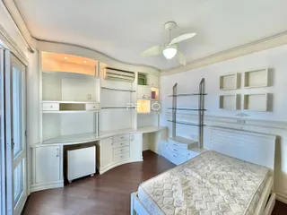 Quarto com armários embutidos e cabeceira.