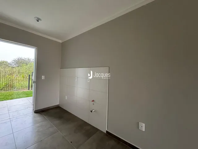 Foto de um corredor interno com porta de acesso ao exterior.