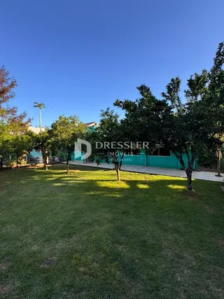 Vista externa de um imóvel com gramado e árvores em Lajeado.