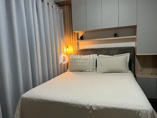 Foto de um quarto com cama e cabeceira em um imóvel.