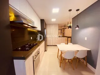 Cozinha moderna com armários escuros e bancadas.