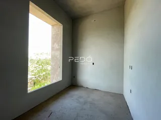 Ambiente interno de um cômodo com grande janela em uma residência.
