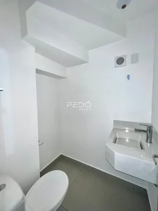 Foto de um banheiro interno com louças brancas.