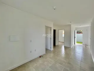 Hall de entrada com piso de cerâmica claro.