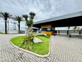 Fachada de uma residência moderna em Lajeado, Brasil, com jardim frontal e área pavimentada.