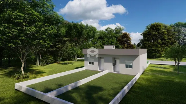 A fachada de uma casa moderna em Lajeado, Brasil, cercada por vegetação.