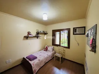 Quarto com cama e janela em ambiente interno.