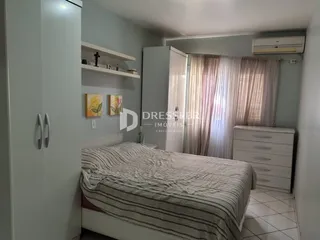 Quarto com cama e armários brancos na residência.
