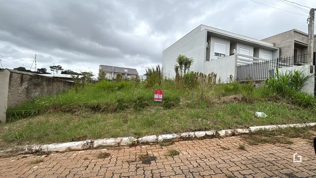 Fachada de uma residência com vegetação alta na frente.
