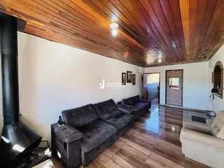Sala de estar com piso de madeira e teto de madeira.