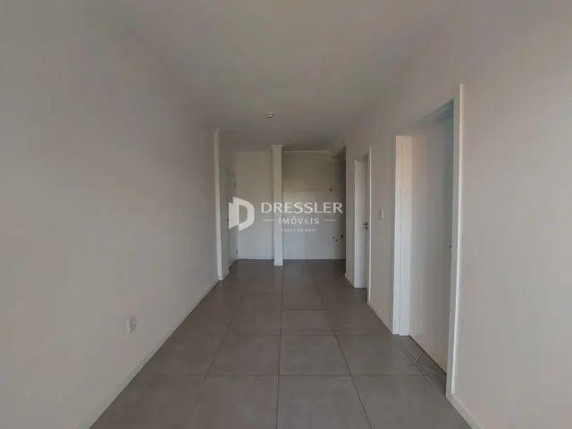 Corredor interno de uma residência com piso de cerâmica.