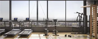 Imagem de uma área comum com equipamentos de ginástica em um imóvel.