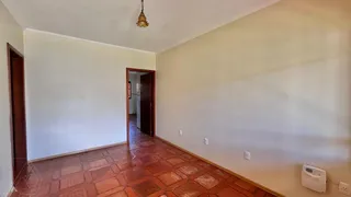 Hall de entrada com piso de ladrilho avermelhado e paredes claras.