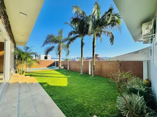 Vista do jardim com palmeiras e muro em Lajeado, Brasil.