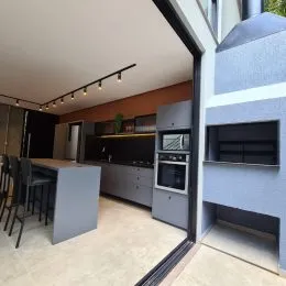 Cozinha com armários e bancada em ambiente interno.