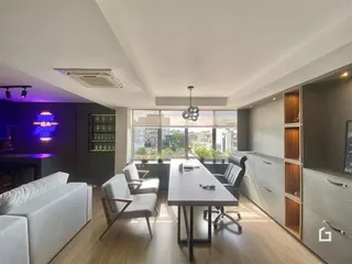 Sala de estar e jantar com piso de madeira clara.