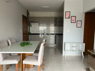 Ambiente interno de uma sala de jantar integrada com a cozinha.