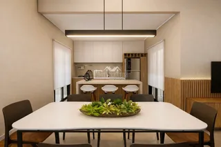 Vista de uma sala de jantar com mesa e ambiente de cozinha moderna.