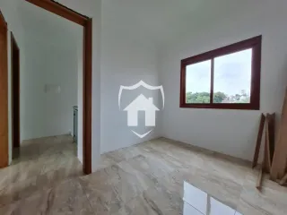 Vista interna de um ambiente com piso de porcelanato claro e janela.