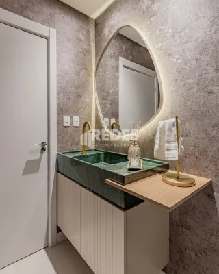 Foto de um banheiro com bancada e espelho em um imóvel.