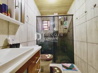 Foto de um banheiro com louças sanitárias e box de vidro.