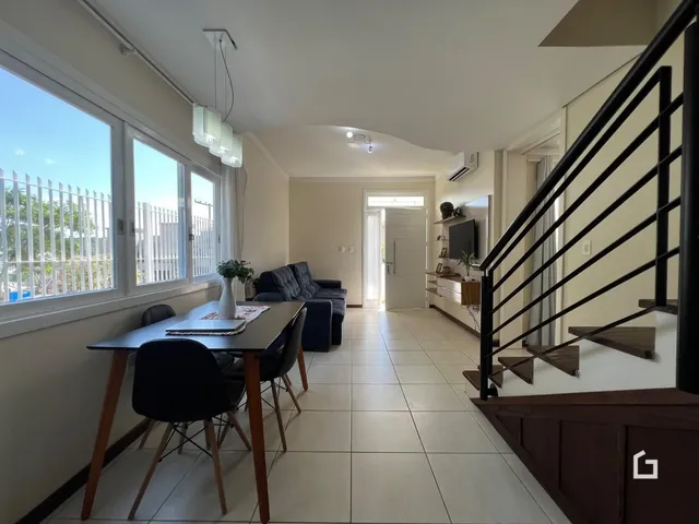 Ambiente interno com mesa de jantar e sala de estar em imóvel no Brasil.
